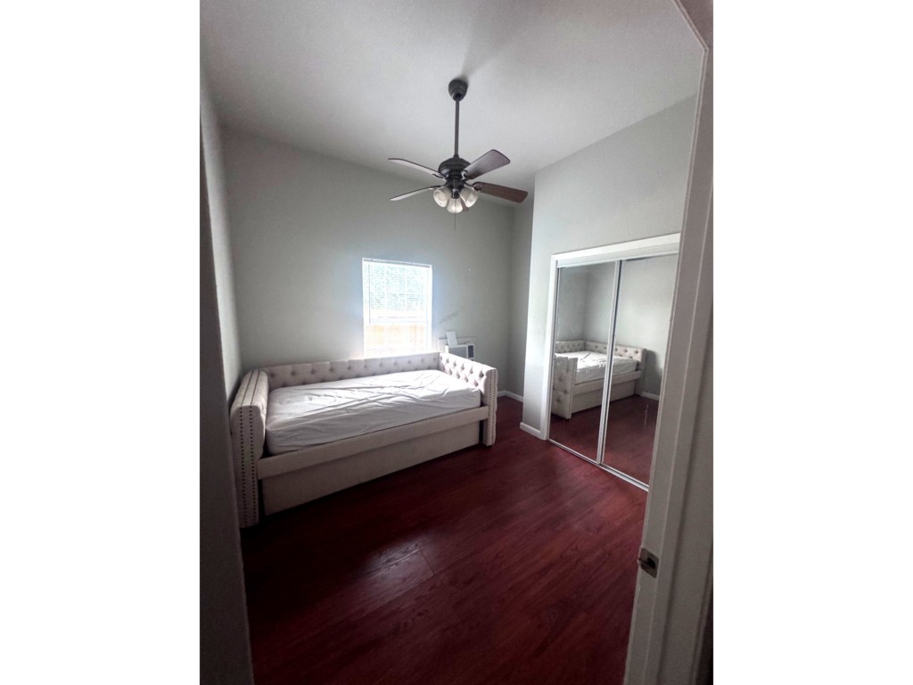 1504 Freeman Street Houston, TX 77009 - Photo 9 of 20 a bedroom with a bed and a chandelier