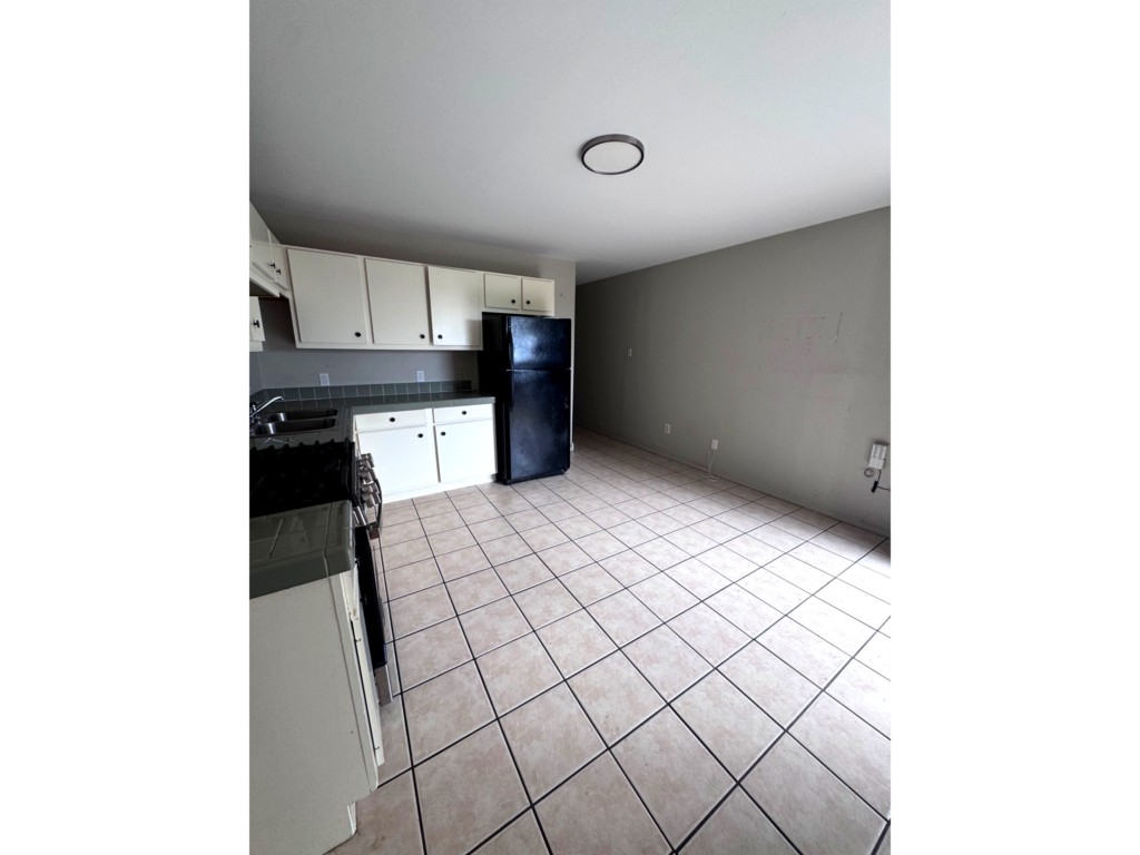 1504 Freeman Street Houston, TX 77009 - Photo 10 of 20 a kitchen with a sink cabinets and window