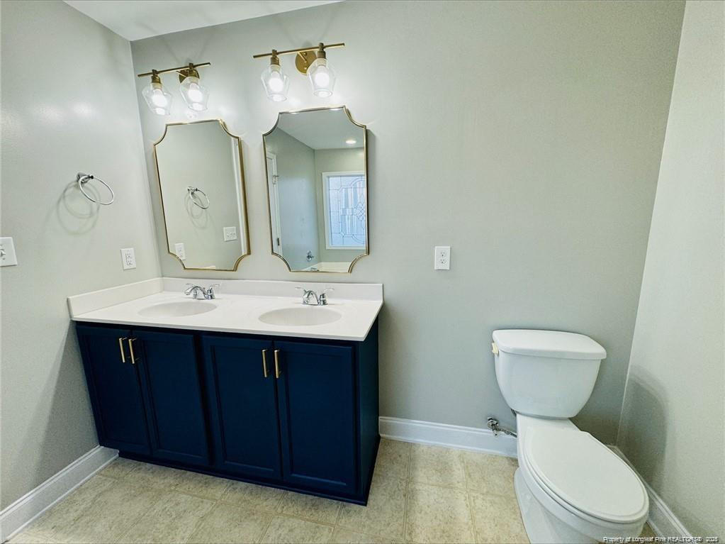 84 Old Glory Lane Cameron, NC 28326 - Photo 5 of 8 a bathroom with a toilet sink and mirror