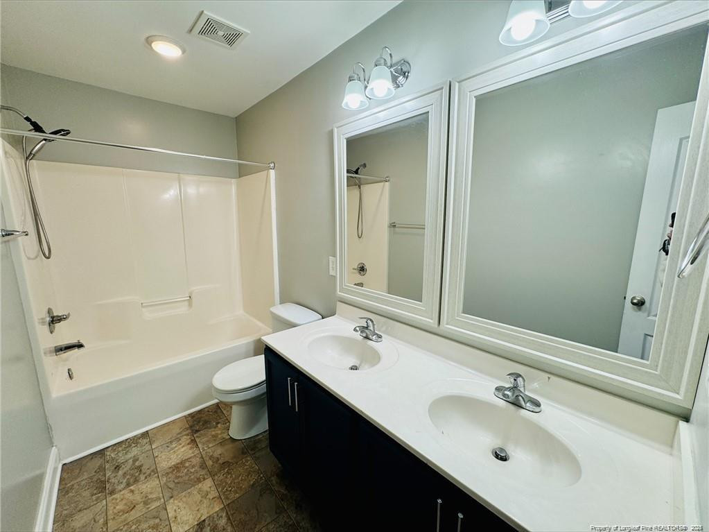 84 Old Glory Lane Cameron, NC 28326 - Photo 7 of 8 a bathroom with a double vanity sink mirror double and a bathtub