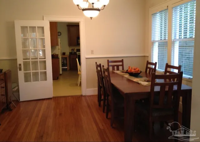 a view of a dining room with furniture and window