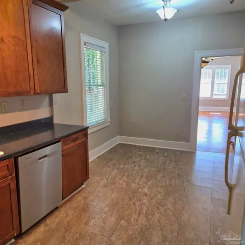 an empty room with windows and wardrobe