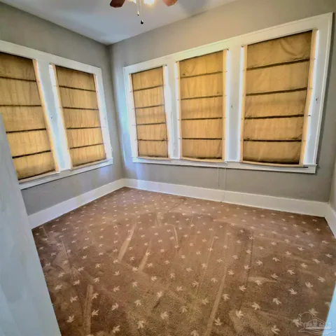 a view of backyard with wooden fence