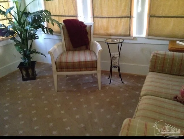 a view of backyard with large trees and wooden fence