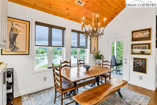 a dining room with furniture a rug and a large window