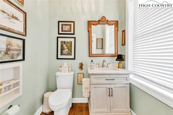 a bathroom with a toilet a sink and a mirror