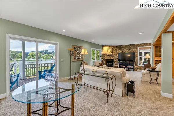 a living room with fireplace furniture and a large window