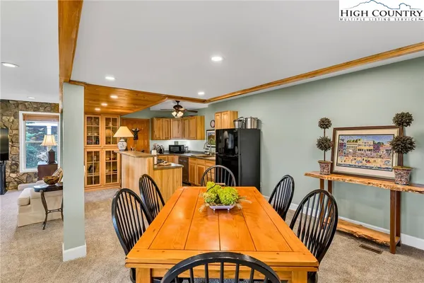 a dining room with furniture and a floor to ceiling window
