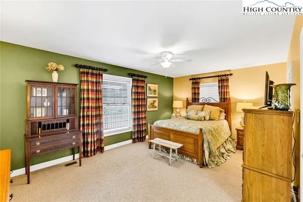 a bedroom with furniture and a flat screen tv