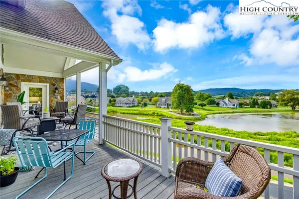 a view of a chair and tables in the balcony