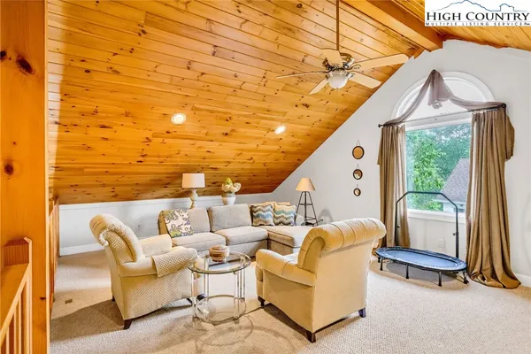 a roof deck with couches and wooden floor