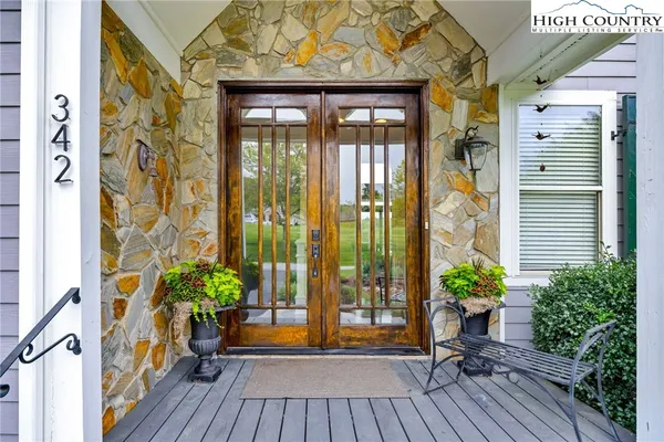 a view of a house with a balcony and wooden floor