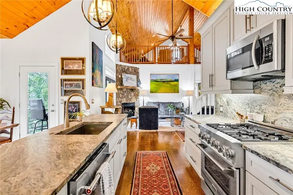 a kitchen with stainless steel appliances granite countertop a stove and a sink