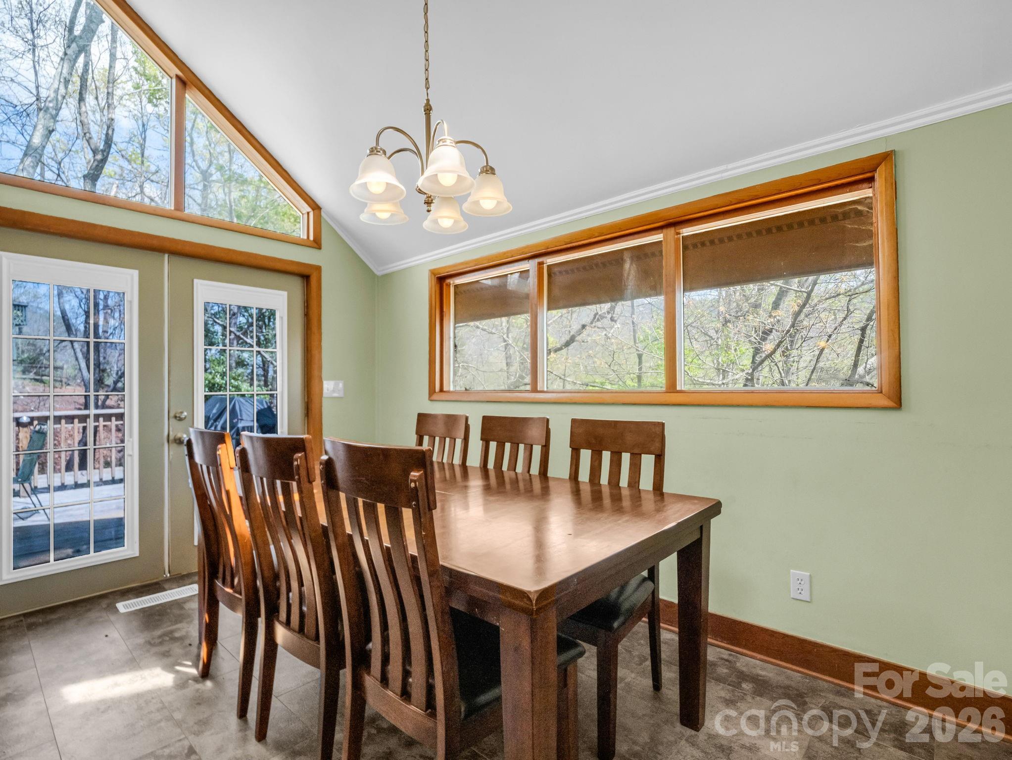 307 Watership Road Lake Lure, NC 28746 - Photo 14 of 48 a view of a dining room with furniture a chandelier and wooden floor