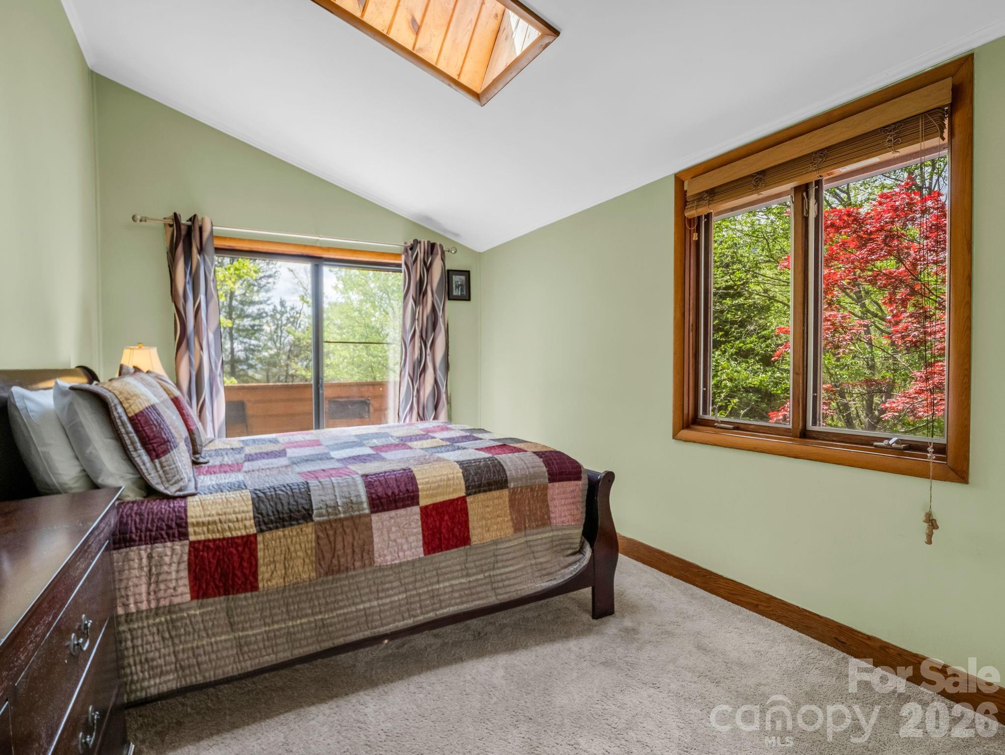307 Watership Road Lake Lure, NC 28746 - Photo 21 of 48 a bed sitting in a bedroom next to a window