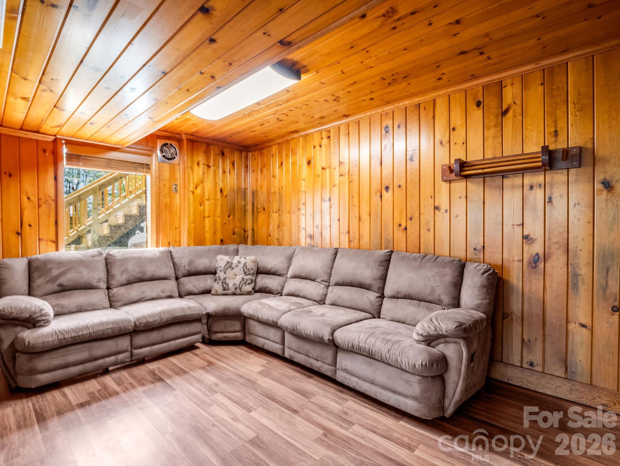 307 Watership Road Lake Lure, NC 28746 - Photo 28 of 48 a living room with furniture a couch and chandelier