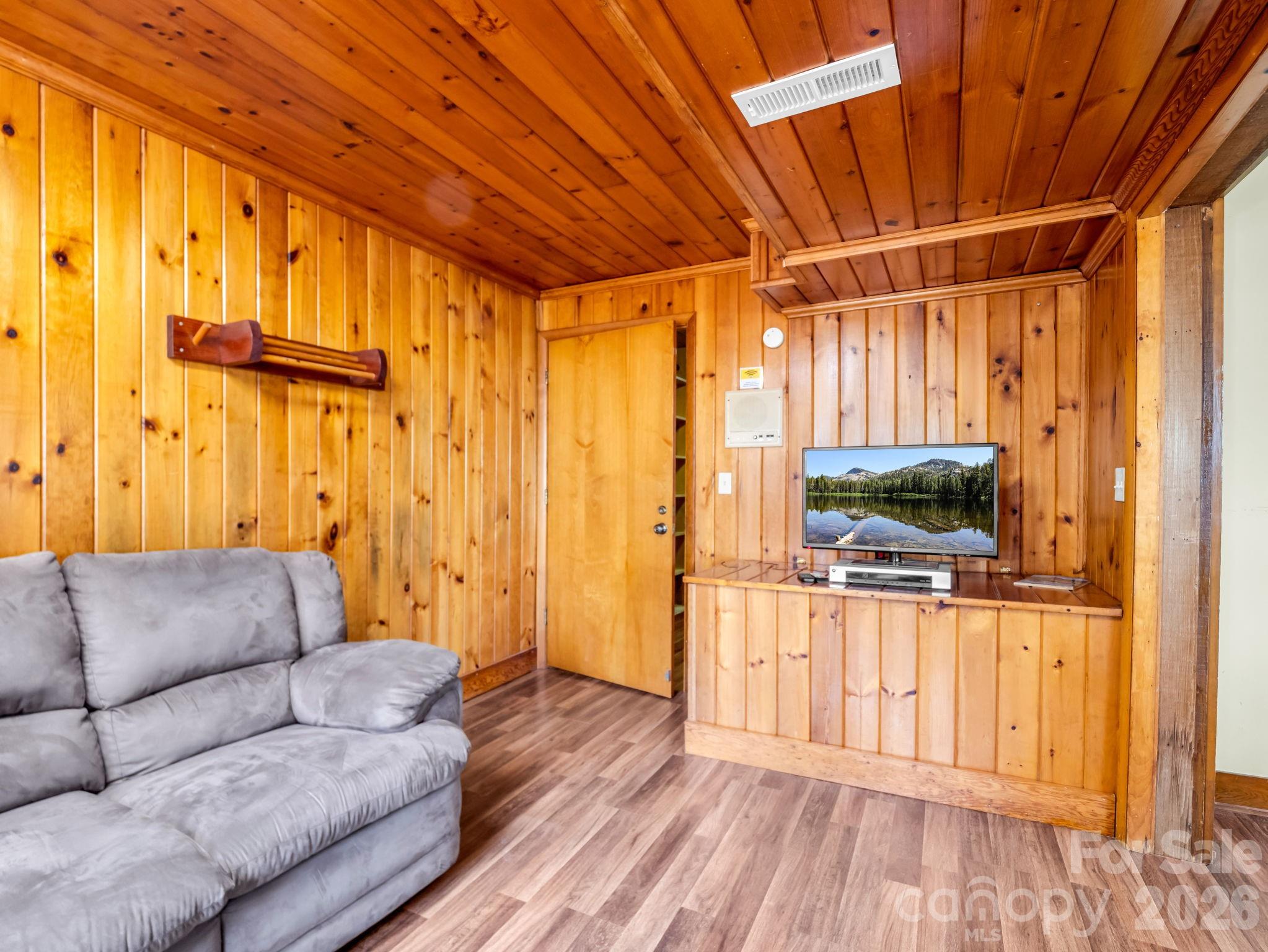 307 Watership Road Lake Lure, NC 28746 - Photo 29 of 48 a living room with furniture and a flat screen tv