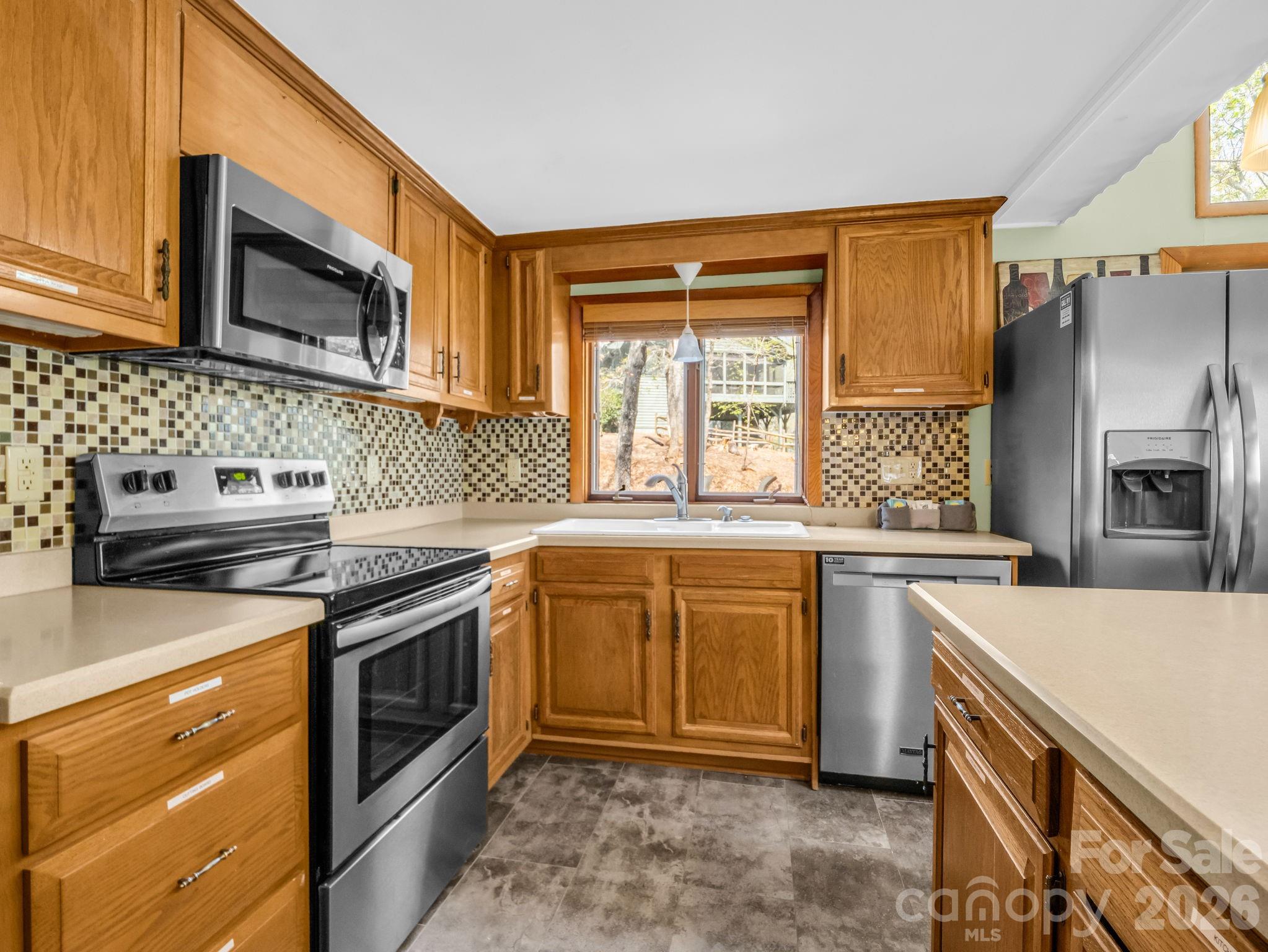 307 Watership Road Lake Lure, NC 28746 - Photo 10 of 48 a kitchen with stainless steel appliances granite countertop a stove sink and microwave