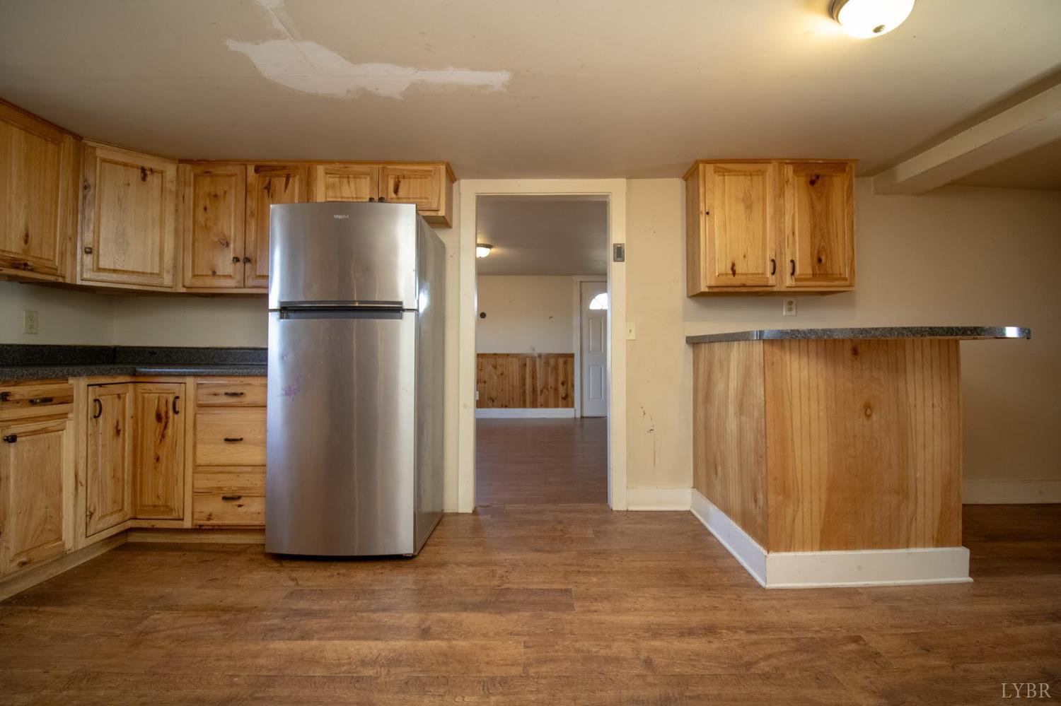 3039 T N Snow Road Nathalie, VA 24577 - Photo 13 of 50 a view of kitchen with refrigerator cabinets and wooden floor