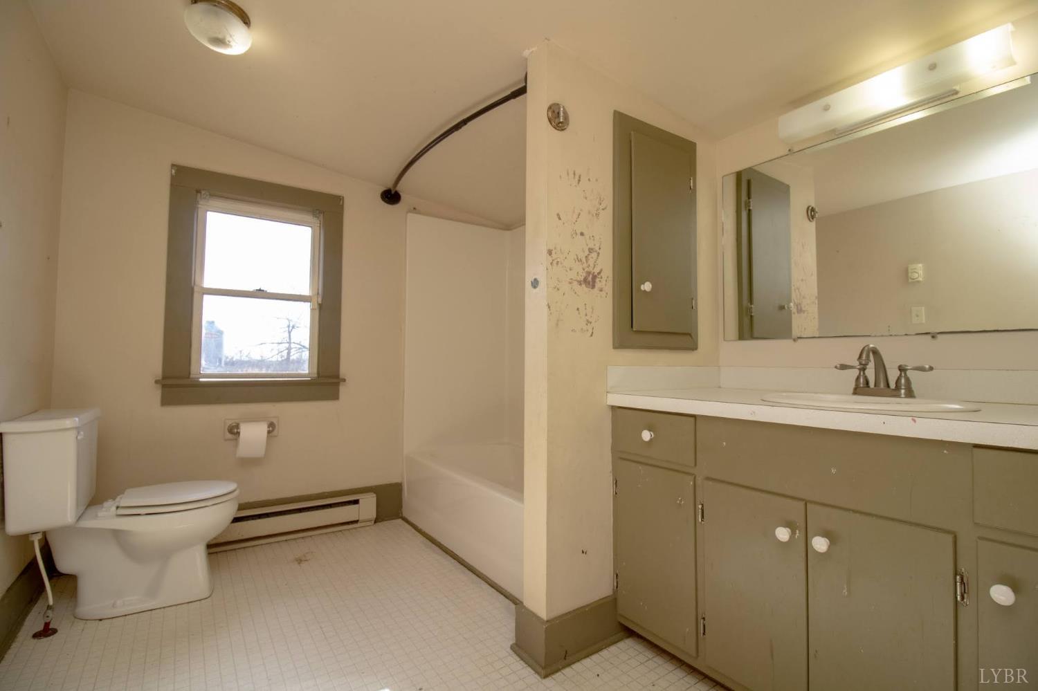 3039 T N Snow Road Nathalie, VA 24577 - Photo 20 of 50 a bathroom with a toilet sink and mirror