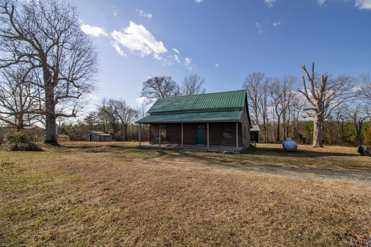 3039 T N Snow Road Nathalie, VA 24577 - Photo 2 of 50 a front view of a house with a yard and a garage