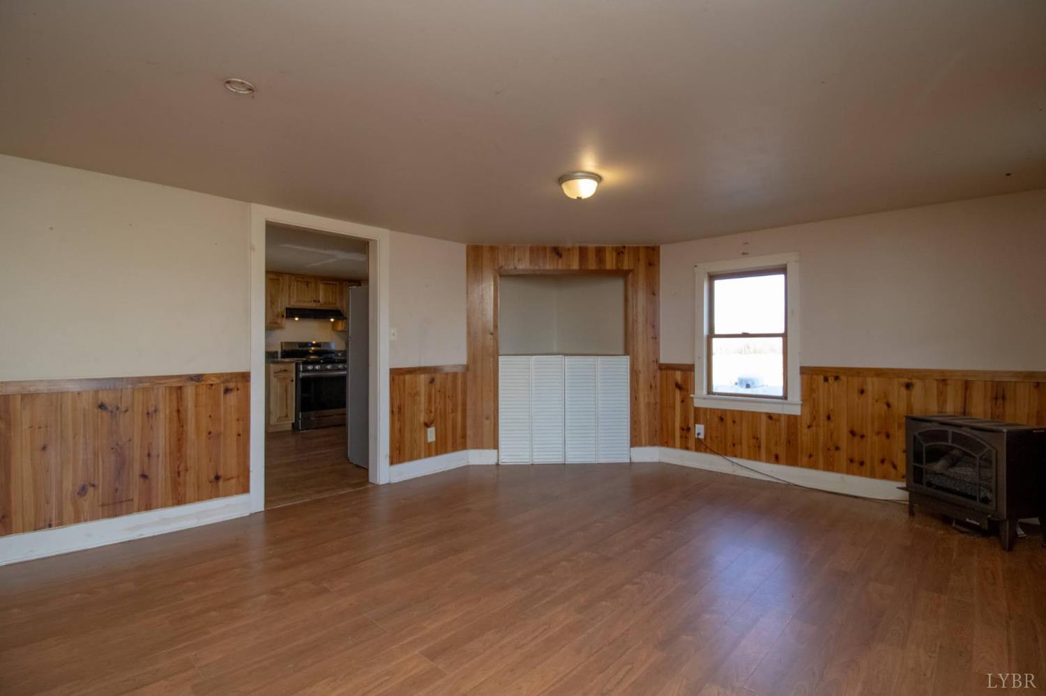 3039 T N Snow Road Nathalie, VA 24577 - Photo 7 of 50 an empty room with wooden floor and windows