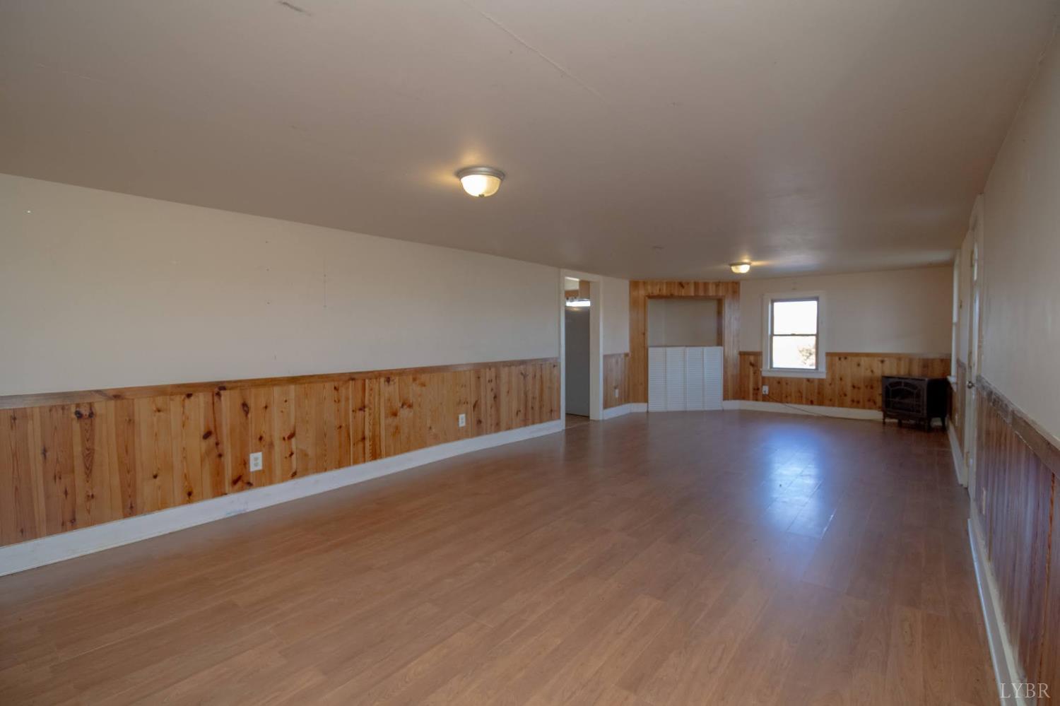 3039 T N Snow Road Nathalie, VA 24577 - Photo 10 of 50 a view of a livingroom with wooden floor and stairs