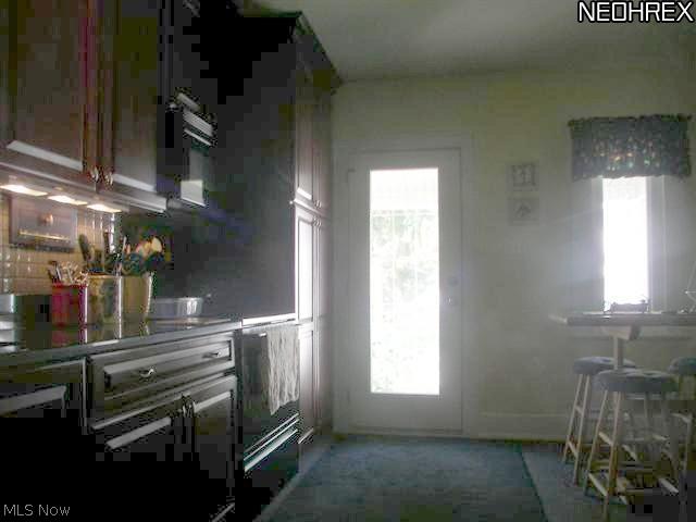 118 Canton Road Akron, OH 44312 - Photo 5 of 24 Another view of kitchen w/ eating area & beveled glass atrium door to covered back porch