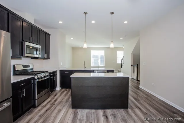 a kitchen with a sink a stove a microwave and cabinets