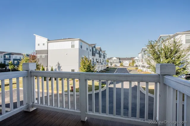 a view of a street with cars parked in front of it