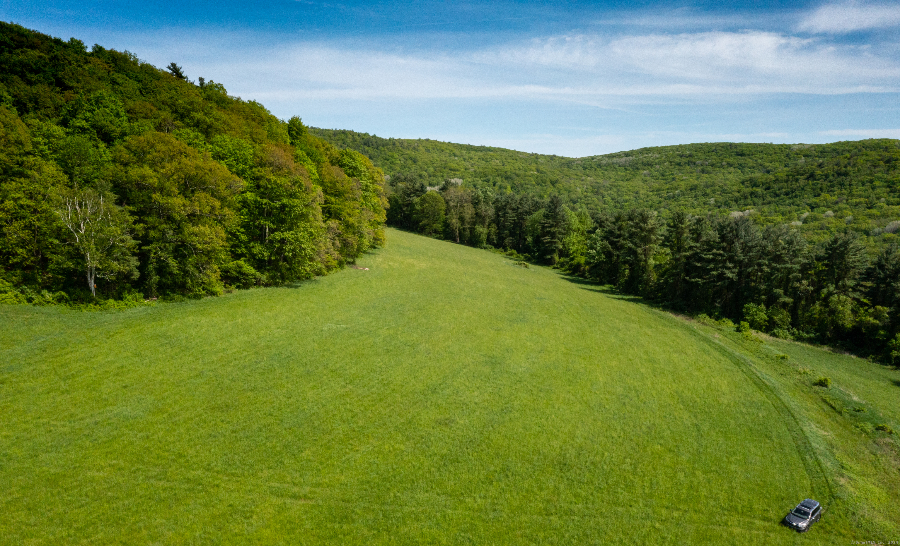 198-2 Beebe Hill Road Falls Village, CT 06031 - Photo 4 of 14 a view of a green field with mountains in the background