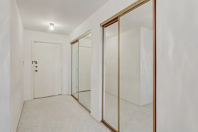 a view of a hallway with closet
