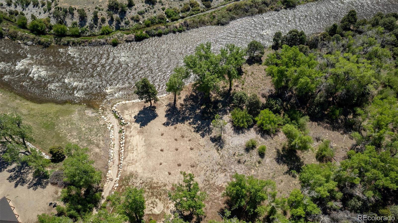 11033 Rivers Edge Lane Salida, CO 81201 - Photo 4 of 48 a view of a yard with plants and large trees