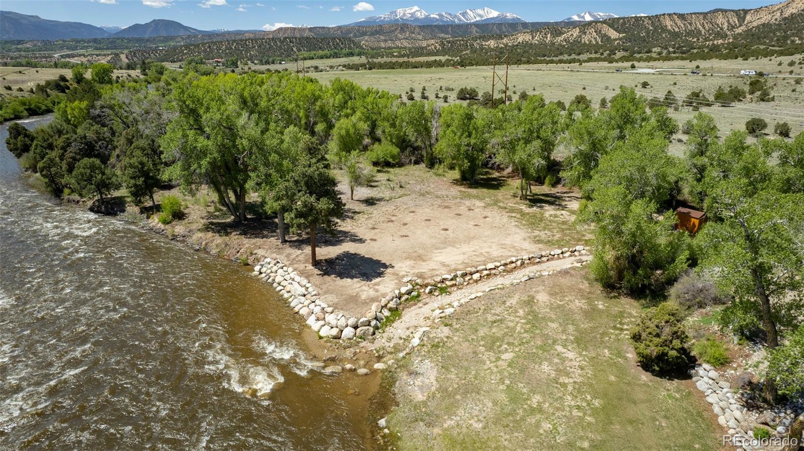 11033 Rivers Edge Lane Salida, CO 81201 - Photo 8 of 48 a view of a lake with mountains and wooden fence