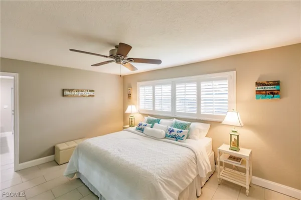 a bedroom with a bed and a television