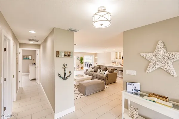 a living room with lots of furniture and view of kitchen