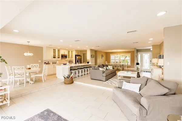 a kitchen with stainless steel appliances kitchen island granite countertop a sink and a stove top oven