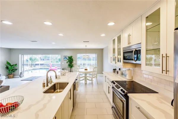 a kitchen with stainless steel appliances kitchen island granite countertop a sink and cabinets