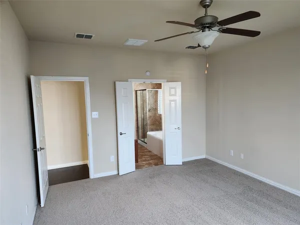 a view of a big room with closet and a chandelier fan