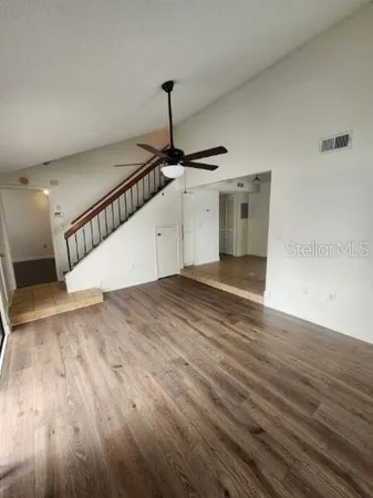a view of an empty room with wooden floor
