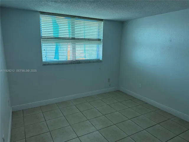 a view of a livingroom with an empty space and a window