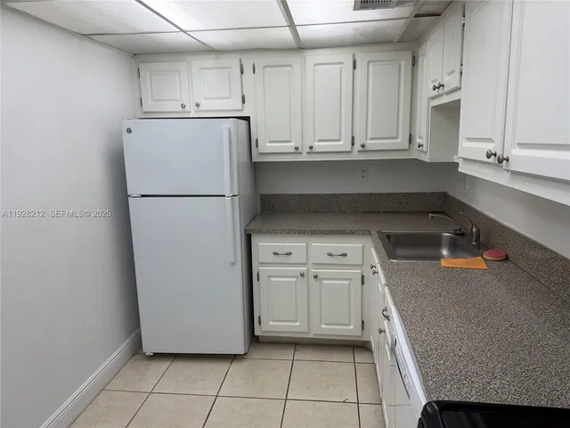 a kitchen with a refrigerator a stove a microwave and cabinets