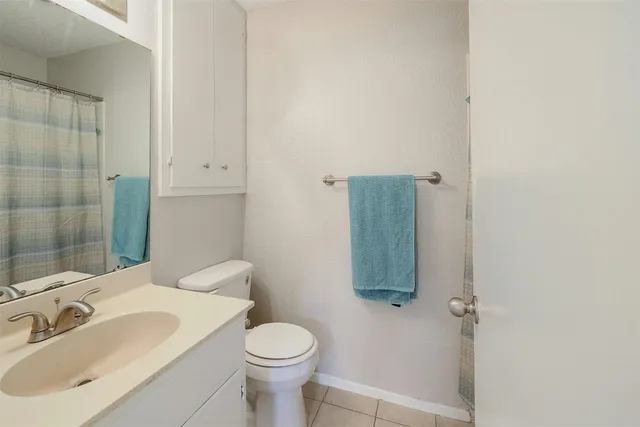 a bathroom with a toilet sink and shower