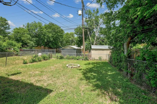 a backyard of a house with a yard and outdoor seating