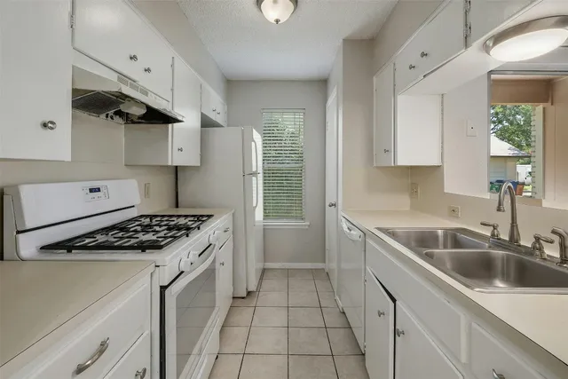 a kitchen that has a sink and a stove
