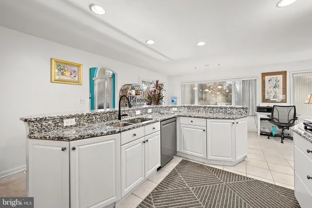 a spacious bathroom with a double vanity sink and mirror