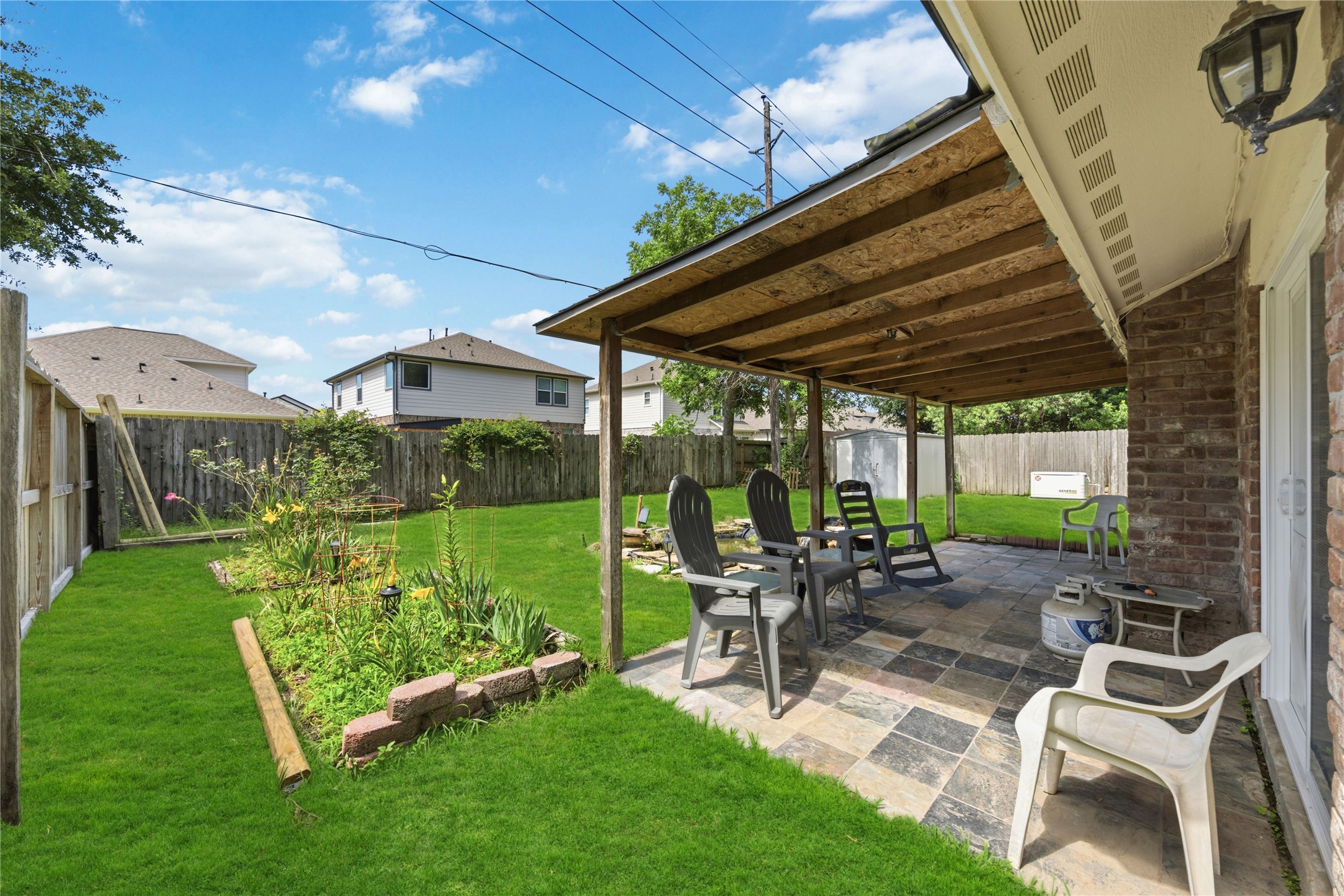9635 Birsay Street Spring, TX 77379 - Photo 23 of 24 a view of a patio with table and chairs with wooden floor and fence