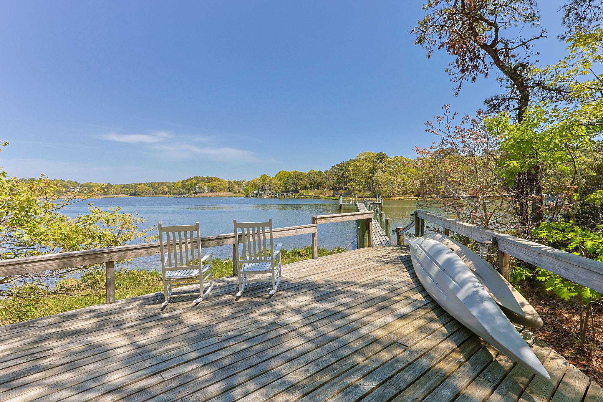 476 Baxter Neck Road Marstons Mills, MA 02648 - Photo 67 of 95 a view of a balcony with wooden chairs and floor to ceiling window