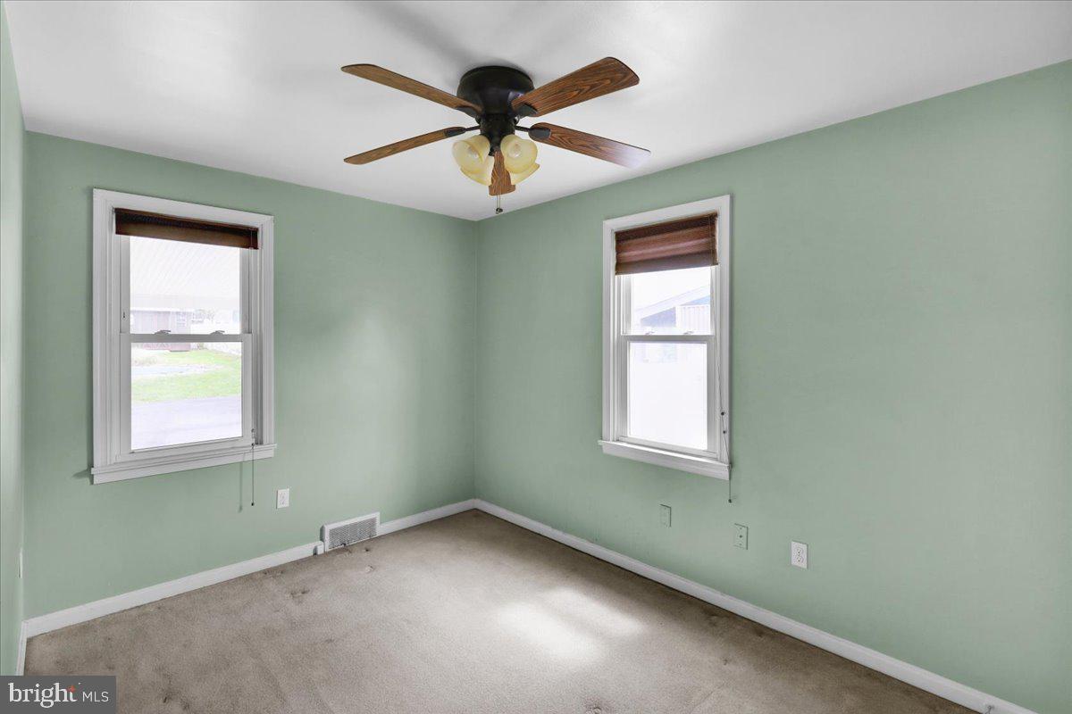 27 Woodland Road Reading, PA 19610 - Photo 14 of 34 an empty room with a window and a fan