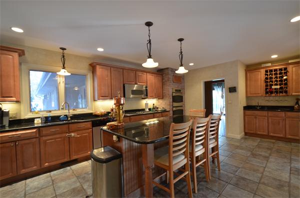 47 Pierpont Road Dudley, MA 01571 - Photo 9 of 30 a kitchen with granite countertop a stove a sink a dining table and chairs
